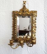 A Baroque brass framed girandole, late 19th century revival, with a bevelled rectangular mirror