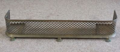 A Regency brass and fretwork fireguard, with paw feet, 24cm high, 120cm wide