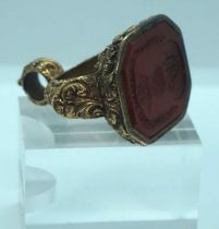 A yellow metal (probably 18 carat gold but untested) fob seal, inset with a agate carved with the