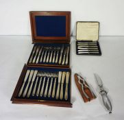 A cased set of six silver butter knives (loaded), together with a cased set of plated fish eaters, a