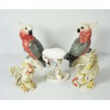 A pair of ceramic figurines of Rose Breasted Galah’s, together with other bird figurines,