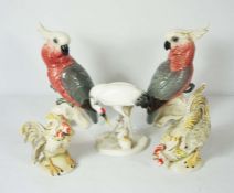 A pair of ceramic figurines of Rose Breasted Galah’s, together with other bird figurines,