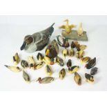A large flock of assorted carved wooden ducks and other birds, largely RNRI Wildlife collection