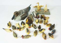 A large flock of assorted carved wooden ducks and other birds, largely RNRI Wildlife collection