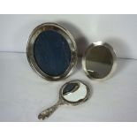 Two silver picture frames, including an oval frame with engine turned decoration, Birmingham 1894,