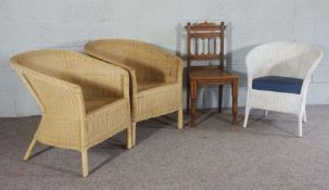 A pair of wicker Colonial style armchairs, together with another smaller painted example and an