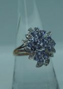 A 14 carat white gold, diamond and tanzanite cluster ring, total gross approx. 5 carats tanzanite,
