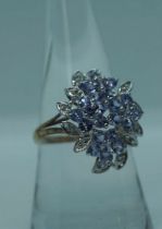 A 14 carat white gold, diamond and tanzanite cluster ring, total gross approx. 5 carats tanzanite,