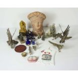 A group of assorted decorative items, including a terracotta classical bust, carved soapstone