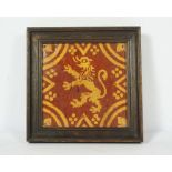 A Flemish slipware decorative tile, 17th century, decorated with a lion rampant within geometric