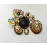 A group of brooches, including a Whitby jet cameo brooch, decorated with the bust of a lady; two