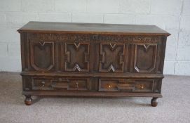 An oak panelled coffer, early 18th century, the hinged top over a fielded panelled front, with