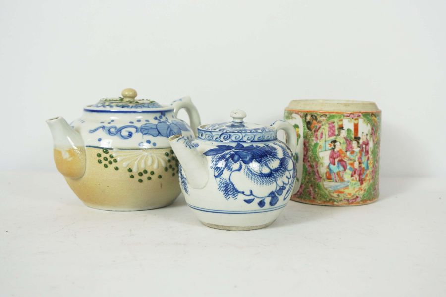 A group of oriental ceramics, including a small bullet form blue and white teapot, two bowls, and