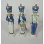 Three LLadro figurines of boy soldiers, in Napoleonic period dress, one with a drum, another a