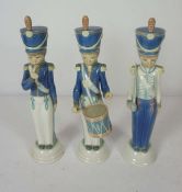 Three LLadro figurines of boy soldiers, in Napoleonic period dress, one with a drum, another a