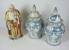 A pair of modern Chinese blue and white covered vases, 50cm high; together with a Chinese ceramic