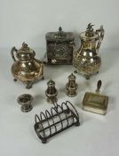 An assortment of assorted silver plated service ware, including a biscuit tin, toast rack, teapot