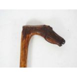 A beautifully carved walking stick, the handle carved with a horses head, inscribed ‘KEPKYPA’,
