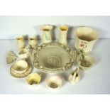 A Belleek basket, together with a group of small Belleek porcelain items, including a jug in the