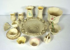 A Belleek basket, together with a group of small Belleek porcelain items, including a jug in the