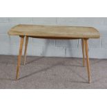 An Ercol ash topped kitchen dining table, mid 20th century, on plain legs, labelled, 130cm long