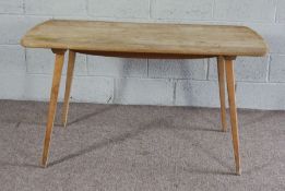 An Ercol ash topped kitchen dining table, mid 20th century, on plain legs, labelled, 130cm long