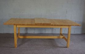 A modern blocked and varnished pine extending dining table, with single additional leaf, late 20th