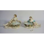 A pair of Staffordshire china sweetmeat baskets, each supported by a reclining figure, 19th century,