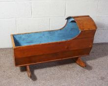 A Victorian child’s rocking cot, 19th century, light blue painted interior, 55cm high, 95cm long