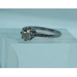 A diamond and platinum set engagement ring, the brilliant cut central diamond (approx 1.07