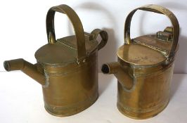 A pair of vintage brass watering cans, with hinged lids and oval ribbed sides, 28cm high (2)