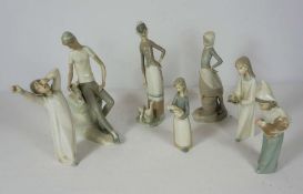 A group of assorted LLadro, including a seated boy and his companion, a child holding a cockerel,