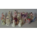 A large group of Royal Doulton bone china figures of ladies, including 'Autumn Breezes, HN.1911