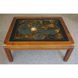 A large hardwood coffee table, inset with a facsimile early map of the world, after Nicolao