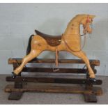 A modern carved childs rocking horse, made by 'Engineering in Wood', circa 2010, the horse with