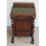 A Victorian style mahogany Davenport, with leathered hinged writing slope, four side drawers and