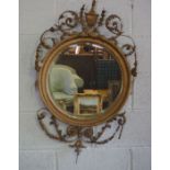 A Regency style composition gilt wall mirror, 19th century, with a circular bevelled plate, egg