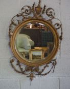 A Regency style composition gilt wall mirror, 19th century, with a circular bevelled plate, egg