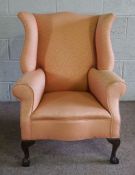 A George III style wing armchair, modern, currently upholstered in salmon pink, with cabriole legs