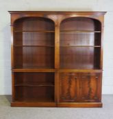 A Georgian reproduction open bookcase, in two sections