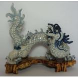 A large Chinese ceramic decorative 'Imperial' five clawed dragon, late 20th century. standing with