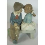 A LLadro figure group of two children on a bench; together with two others similar and a quantity of
