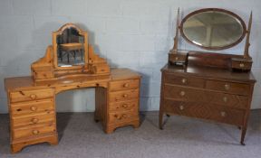 An early 20th century mahogany veneered dressing chest, with oval swing mirror, 154cm high, 107cm