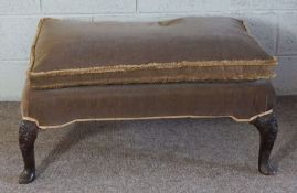 A George II style mahogany footstool, 18th century and later, currently upholstered in brown