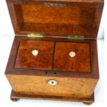 A late Regency birds eye maple veneered tea caddy, fitted with two compartments, of sarcophagus