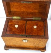 A late Regency birds eye maple veneered tea caddy, fitted with two compartments, of sarcophagus