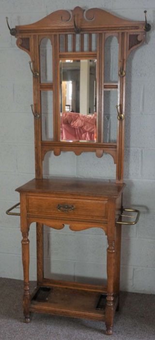 An Edwardian oak hall stand, circa 1910, with a shaped mirror set back with seven hat hooks, over - Image 4 of 8