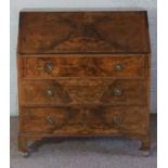 A reproduction George II walnut veneered bureau, with fall front, and three drawers, 107cm high,