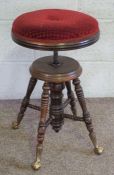A Chas. Parker adjustable piano stool, with ring turned legs, rotating height adjustable seat,