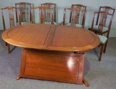 A modern and large hardwood dining suite, the extending table including one additional leaf, on ring